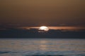 distant sunset in the middle of the sea Royalty Free Stock Photo