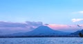 Distant susnset view of Nyiragongo Mountain in Democratic Republic of Congo, seen from Lake Kivu, Rwanda.