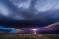 Distant thunderstorm lightning strike over a dirt road Royalty Free Stock Photo