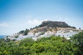 Distant view at Lindos Town and Castle with ancient ruins of the Acropolis on sunny warm day. Island of Rhodes, Greece. Europe Royalty Free Stock Photo