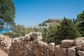 Distant view at Lindos Town and Castle with ancient ruins of the Acropolis on sunny warm day. Island of Rhodes, Greece. Europe Royalty Free Stock Photo