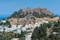 Distant view at Lindos Town and Castle with ancient ruins of the Acropolis on sunny warm day. Island of Rhodes, Greece. Europe Royalty Free Stock Photo