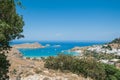 Distant view at Lindos Town and Castle with ancient ruins of the Acropolis on sunny warm day. Island of Rhodes, Greece. Europe Royalty Free Stock Photo