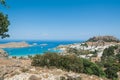 Distant view at Lindos Town and Castle with ancient ruins of the Acropolis on sunny warm day. Island of Rhodes, Greece. Europe Royalty Free Stock Photo