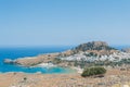 Distant view at Lindos Town and Castle with ancient ruins of the Acropolis on sunny warm day. Island of Rhodes, Greece. Europe Royalty Free Stock Photo