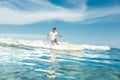 distant view of male surfer riding on board in ocean at Nusa Dua Beach