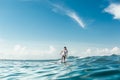 distant view of male surfer riding on surfing board in ocean at Nusa Dua Beach