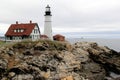 Distant view of Portland Head lighthouse, with stormy skies and rough seas, Maine,2016 Royalty Free Stock Photo