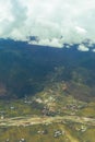 Distant view of rural settlement along mountainous countryside in Druk Bhutan Royalty Free Stock Photo