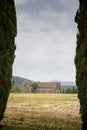 Distant view of san galgano abbey between two cypresses Royalty Free Stock Photo