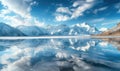 A distant view of snow-capped mountains reflected in the frozen surface of a lake Royalty Free Stock Photo