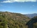 Distant view of village between the hills in the himalayan region of uttarakhand state of india Royalty Free Stock Photo