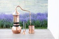 Distillation of lavender essential oil and hydrolate. Copper alambik for the flowering field.