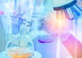 Distillation set with dropping funnels is separating the component substances from liquid mixture with hand scientist holding flas Royalty Free Stock Photo