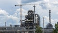 Distillation tower or column on blue sky with clouds background. Oil refinery plant. Refining complex Royalty Free Stock Photo