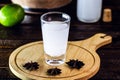 Distilled drink,anise base, on wooden background. Traditional Turkish and Greek appetizer, known as Ouzo, Uzo, Raki, arak or raki Royalty Free Stock Photo