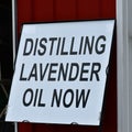 Distilling Lavender Now Sign Against Building