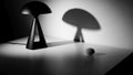 Distinct shadow on a white surface. The lamp features a triangular Royalty Free Stock Photo