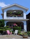 Distinct style of house with large balconies and colorful gardens
