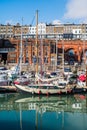 Distinctive buildings and boats in Ramsgate Royal Harbour reflecting in the water of the marina