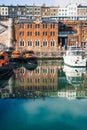 Distinctive buildings and boats in Ramsgate Royal Harbour reflecting in the water of the marina