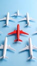 Distinctive red airplane among a crowd of white model aircraft on a blue background Royalty Free Stock Photo