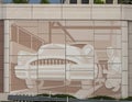 Distinctive wall mural featuring a car mechanic along Interstate 30 in Arlington, Texas.