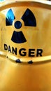 Warning sign on yellow crumpled metal surface