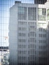 Distorted reflection of a high-rise building on glass windows