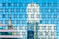 Distorted reflections of buildings in a glass facade from a modern architectural complex. The architectural appearance of the city Royalty Free Stock Photo