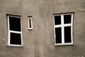 Distorted window with white frame on grey old wall architecture Royalty Free Stock Photo