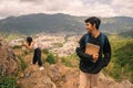 Distracted first-year Latino student with his classmate recording videos for social networks