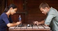 Distracted by technology. Two young adults being distracted by technology while out on a coffee date. Royalty Free Stock Photo