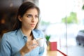 Distracted woman drinking coffee in a bar