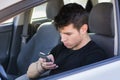 Distracted Young Man Using Cell Phone While Royalty Free Stock Photo