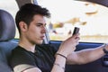 Distracted Young Man Using Cell Phone While Royalty Free Stock Photo