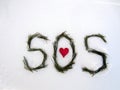 A distress call on the white snow. Love sends a distress signal - SOS. Royalty Free Stock Photo