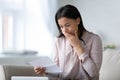 Unhappy biracial woman read bad news in letter Royalty Free Stock Photo