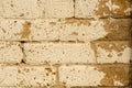 Distressed beige paint on tan brick wall Royalty Free Stock Photo