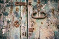 Distressed door detail. Closed old wooden door with rusty lock and handle