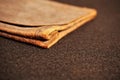 Distressed leather document holder isolated on black felt background