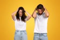 Distressed man and woman with hands on their heads, displaying expressions of intense stress or headache Royalty Free Stock Photo