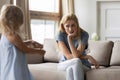 Distressed mom with pity face listening to capricious little daughter Royalty Free Stock Photo