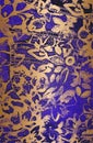Distressed overlay texture of golden blue violet fabric. Textile with eastern floral ornament, leaves and flowers. grunge Royalty Free Stock Photo
