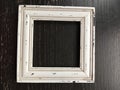 Distressed rustic wood picture frame on a black background