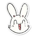 distressed sticker of a cartoon crazy happy bunny face