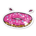 distressed sticker cartoon doodle of an iced ring donut