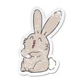 distressed sticker of a cartoon laughing bunny rabbit