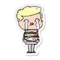distressed sticker of a cartoon man crying over stack of books Royalty Free Stock Photo