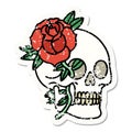 traditional distressed sticker tattoo of a skull and rose